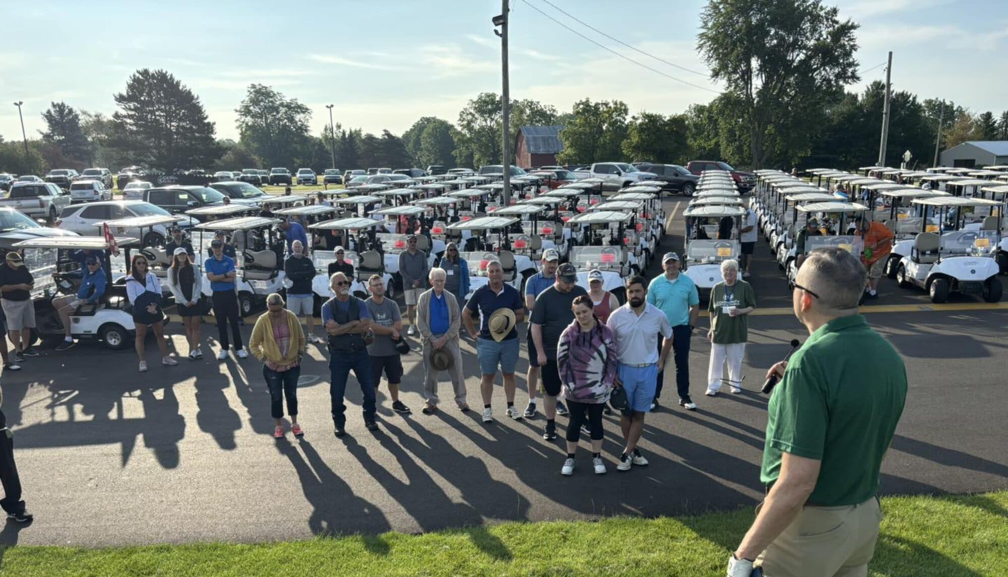 Families gathered in the parking lot at the annual Car Show for Christ