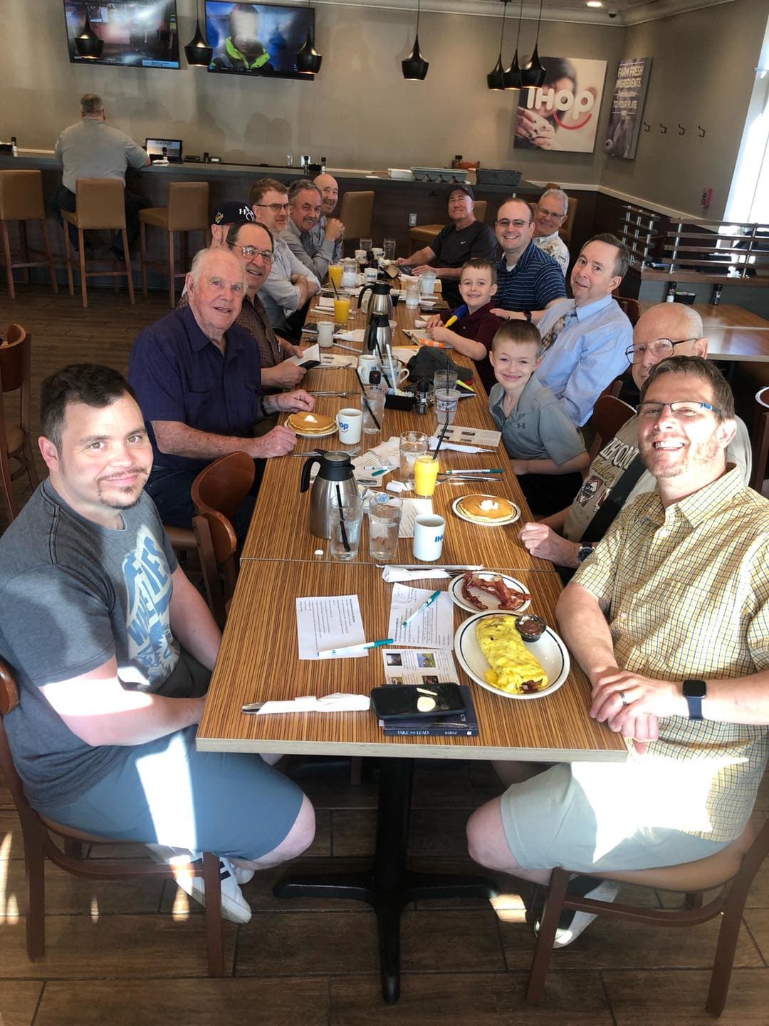 Men praying together over breakfast